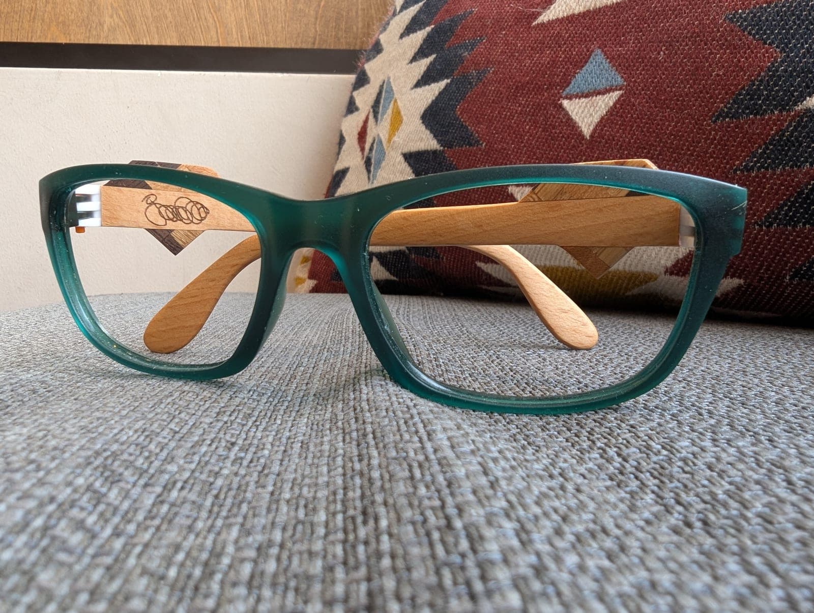 Front view of teal upcycled material eyeglasses with light maple wood temples